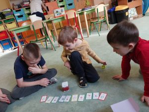 Dzieci układają karty do kodowania i kodują "słonia" po czym robot wykonuje zakodowane czynności