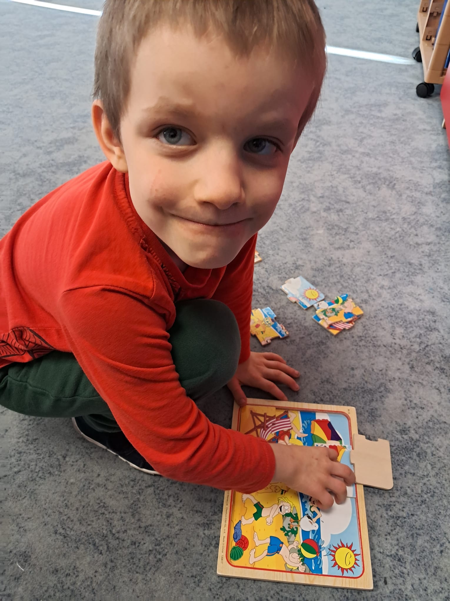 Chłopiec układa układankę